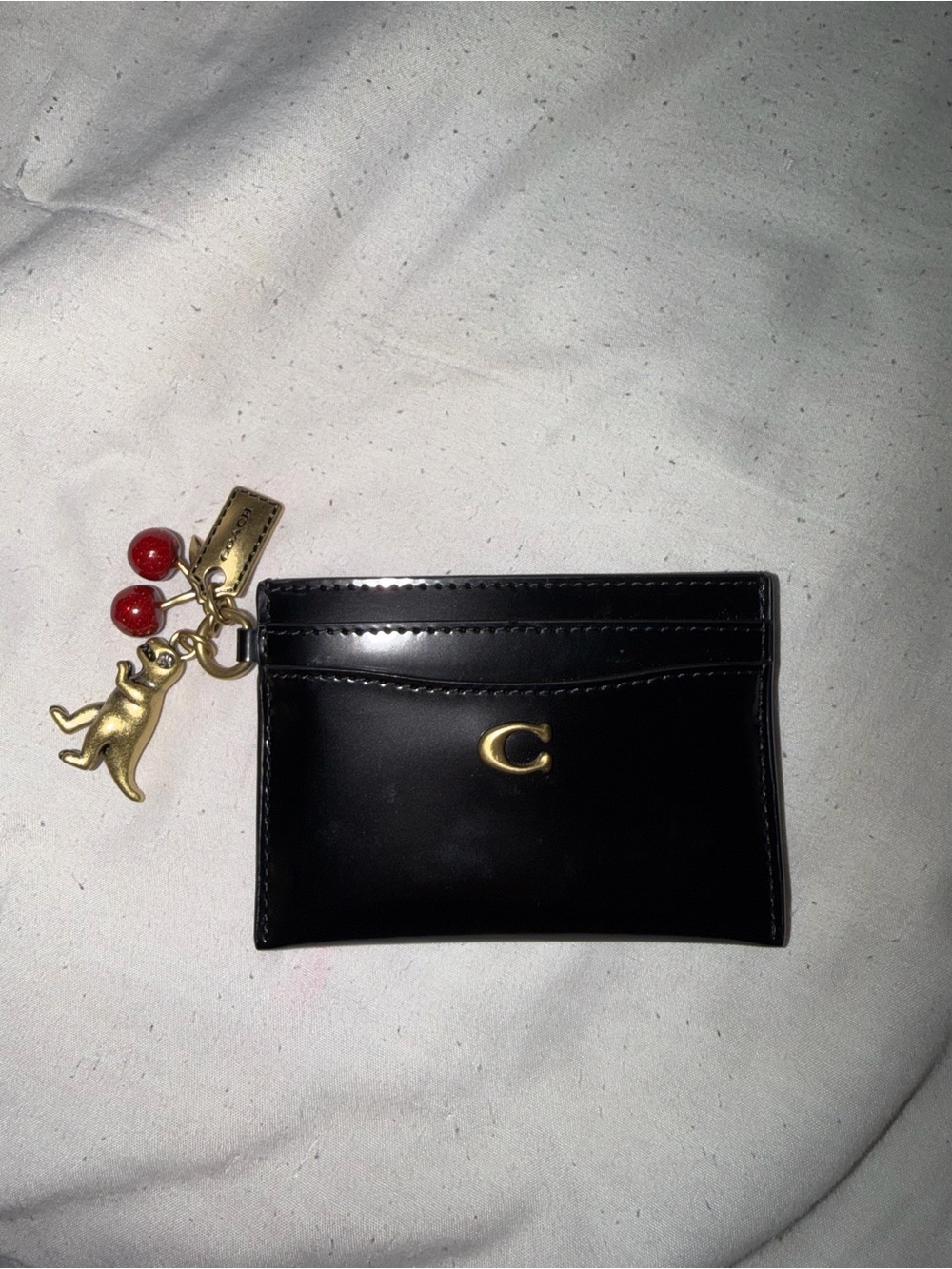 Coach black spazzolato card case wallet with charms